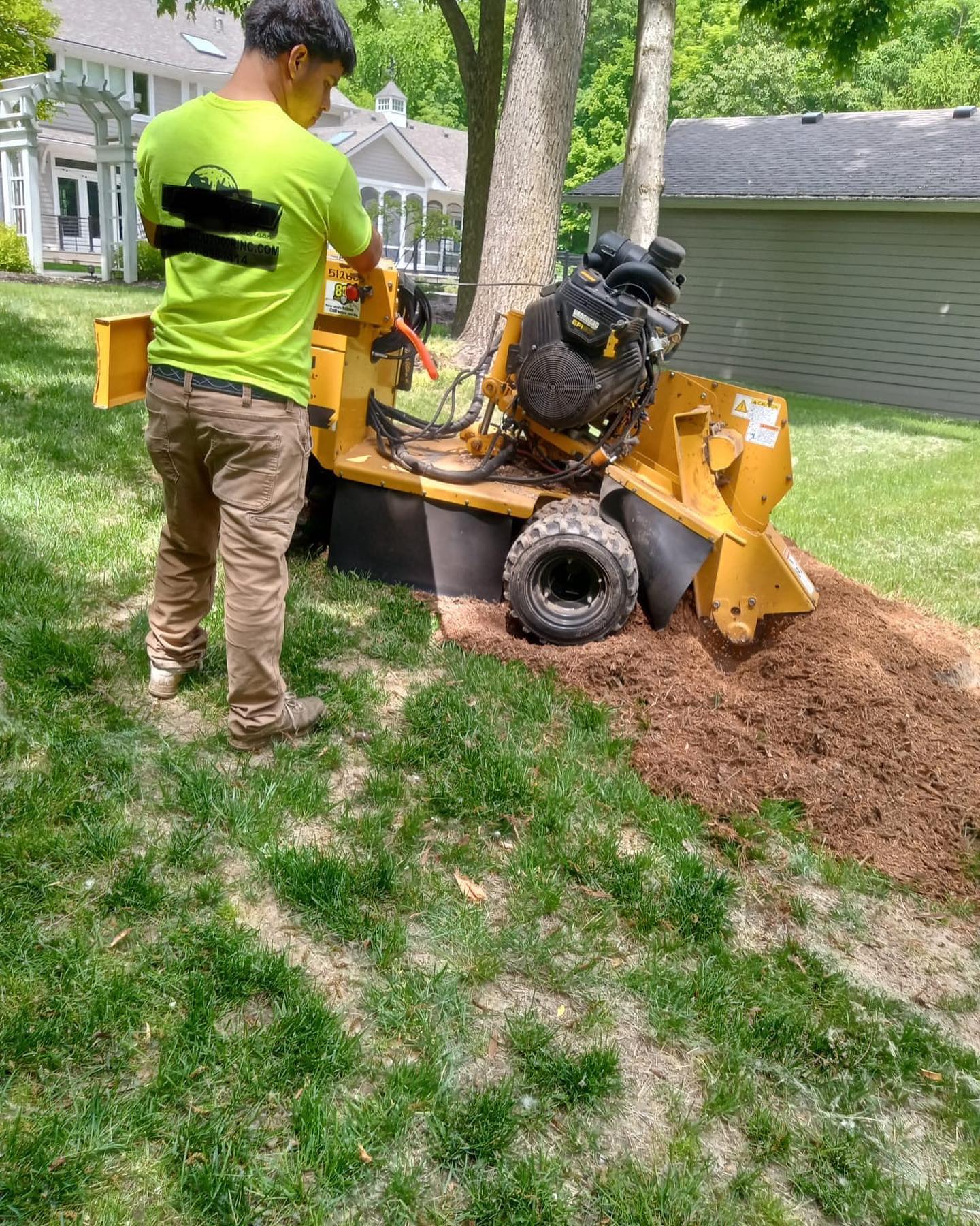 LHLandscape crew member operating a stump grinder