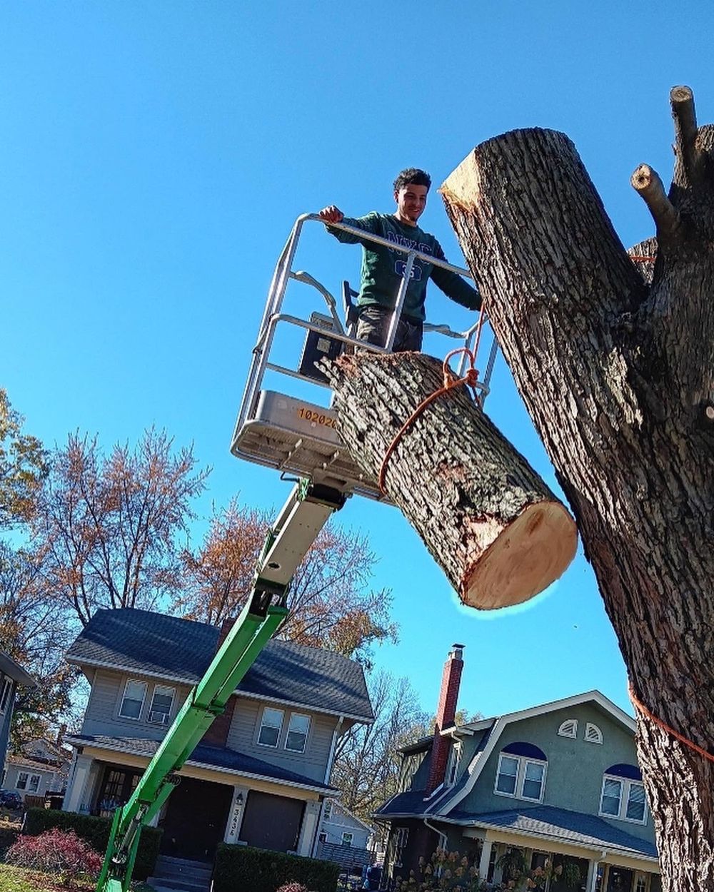 Luis Huerta removing a large tree limb on a lift
